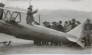 Ray Crawford preaching from the airplane 'The Sky Pilot'.
